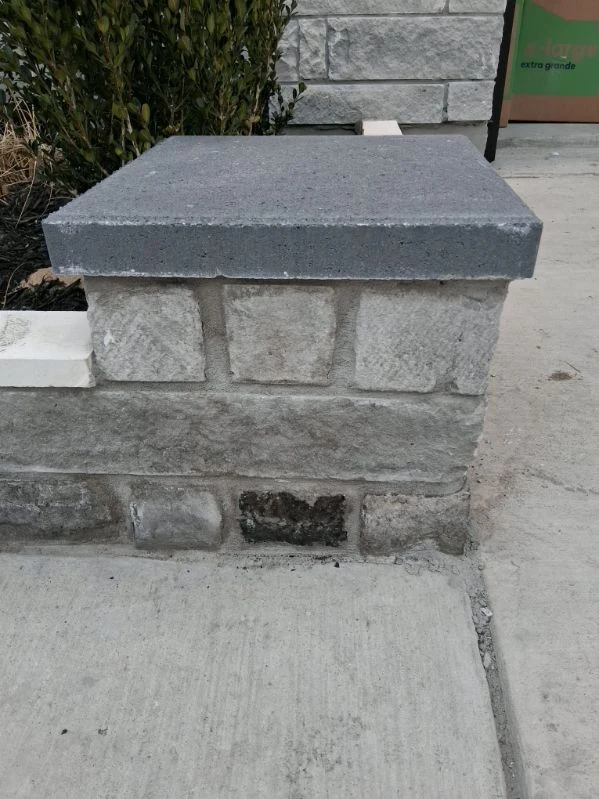 A rectangular cap finishes a small stone landscape pillar.